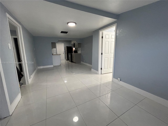 corridor featuring light tile patterned floors