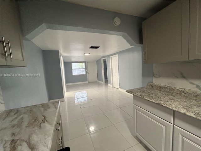 kitchen with light stone countertops and light tile patterned flooring