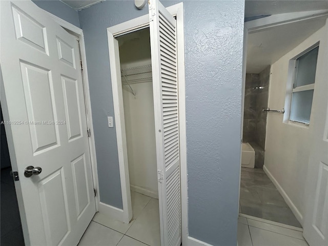 bathroom with tiled shower / bath combo and tile patterned floors