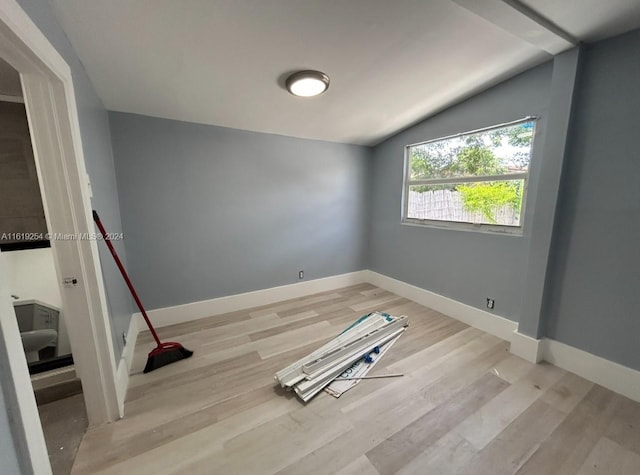 empty room featuring light hardwood / wood-style floors and lofted ceiling