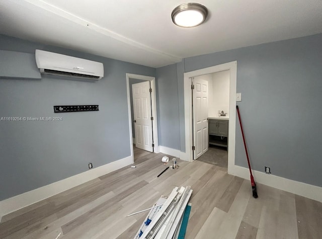 interior space with light hardwood / wood-style floors and a wall mounted air conditioner