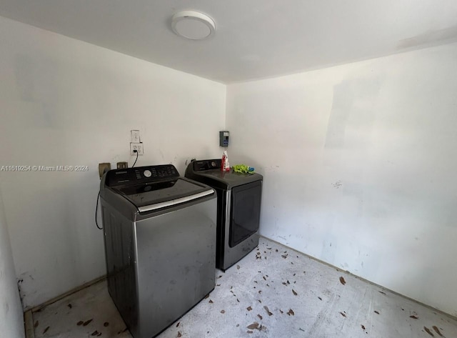 clothes washing area featuring independent washer and dryer