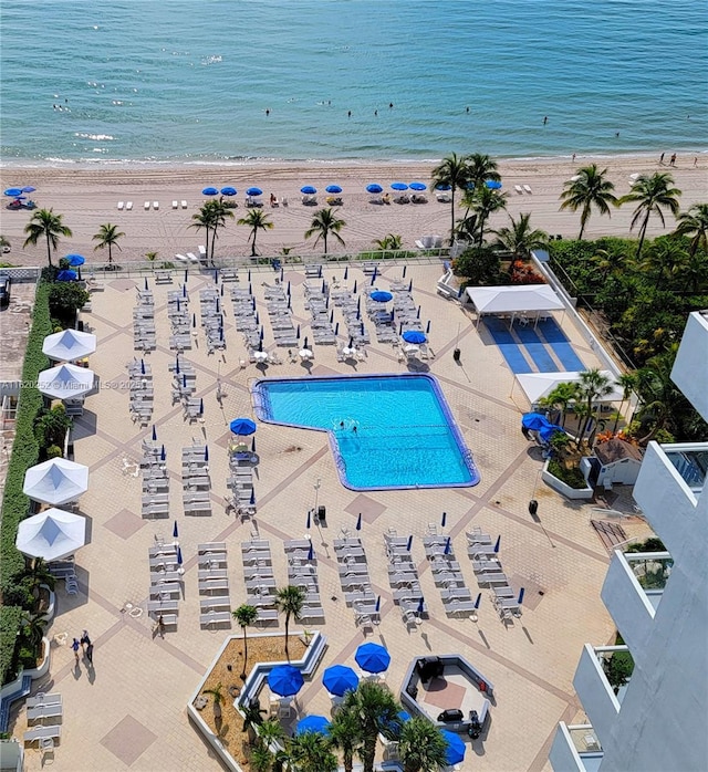 drone / aerial view featuring a water view and a beach view