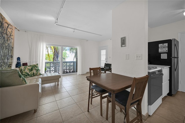 tiled dining area featuring rail lighting