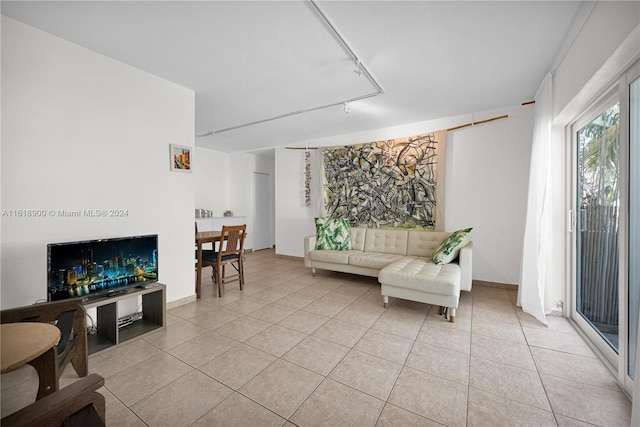 living room with light tile patterned floors and track lighting