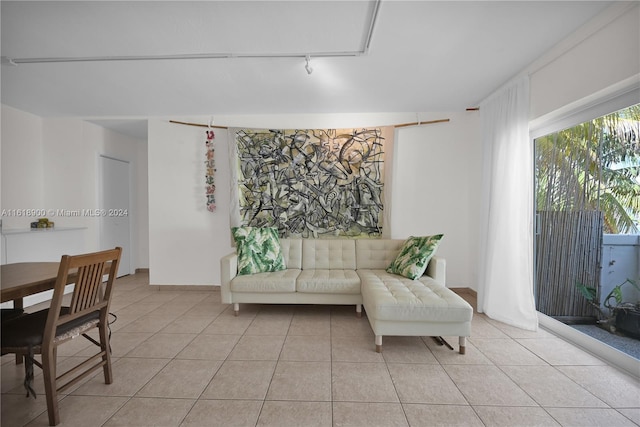 living room featuring light tile patterned floors and rail lighting