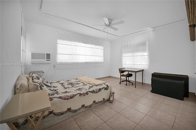 bedroom featuring a wall mounted AC, ceiling fan, and light tile patterned floors