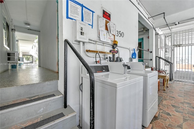 clothes washing area with washing machine and clothes dryer