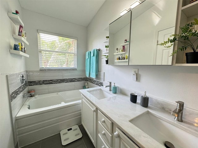 bathroom with dual vanity and a tub to relax in