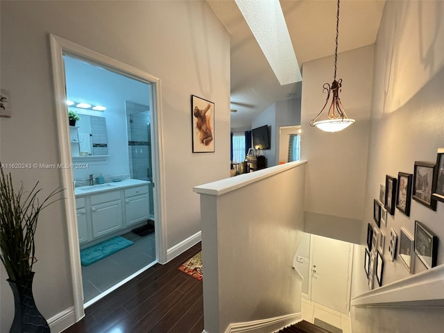 corridor with sink and dark hardwood / wood-style floors