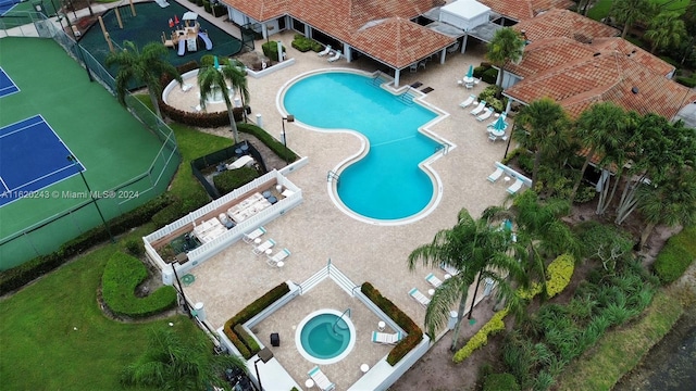 view of pool featuring tennis court and a patio area