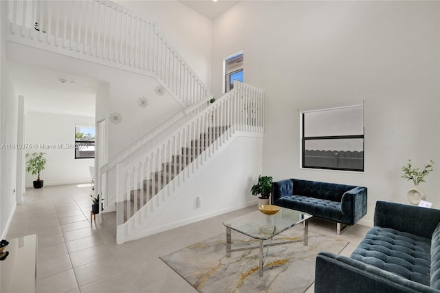 living room featuring light tile patterned floors and a high ceiling