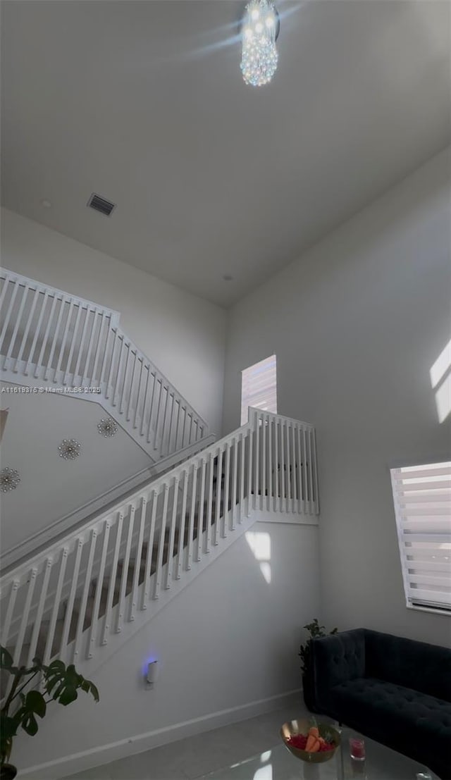 stairway with visible vents and baseboards