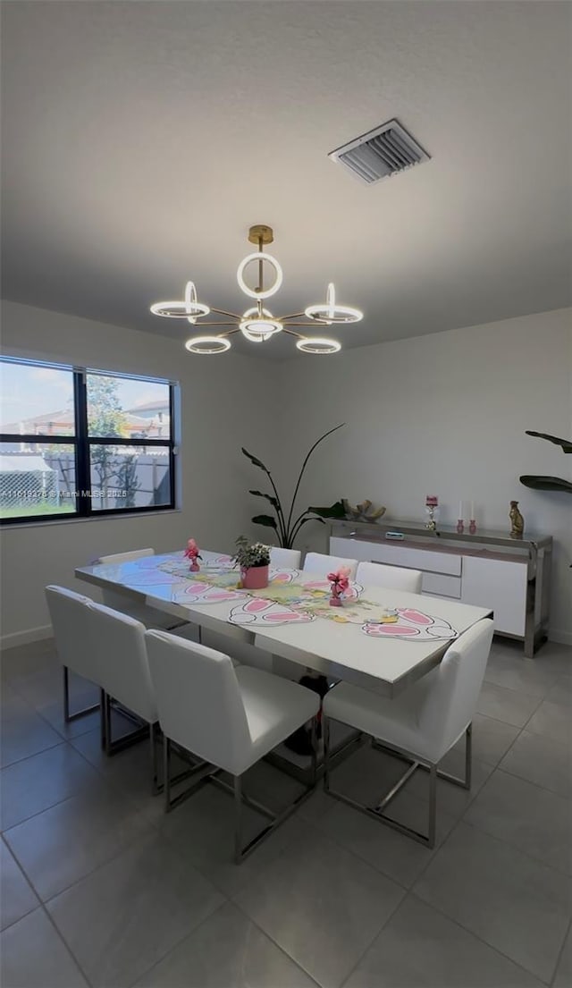 dining area with light tile patterned floors, baseboards, and visible vents