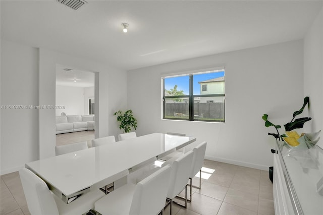 dining area with visible vents, baseboards, and light tile patterned floors