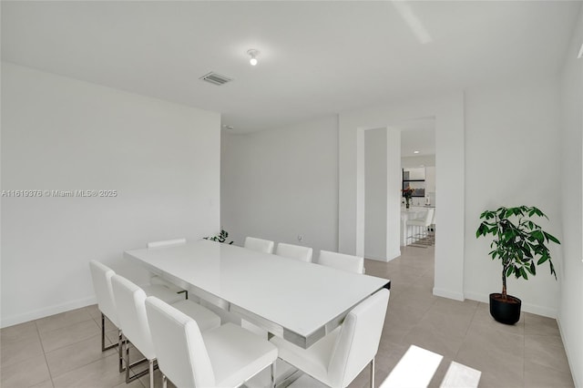 dining space featuring visible vents, baseboards, and light tile patterned floors