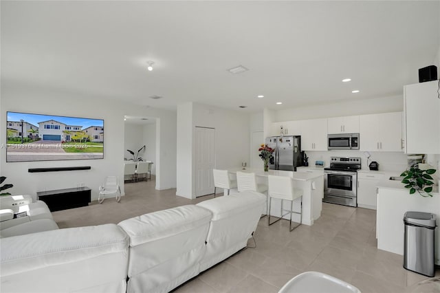 living area featuring recessed lighting and light tile patterned flooring