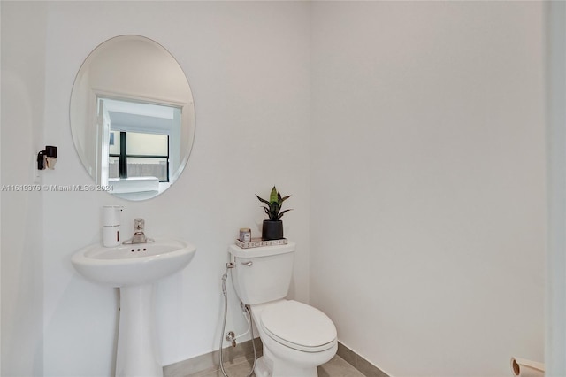 bathroom with toilet and tile patterned floors