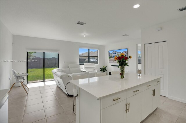 bedroom featuring light colored carpet and a tray ceiling