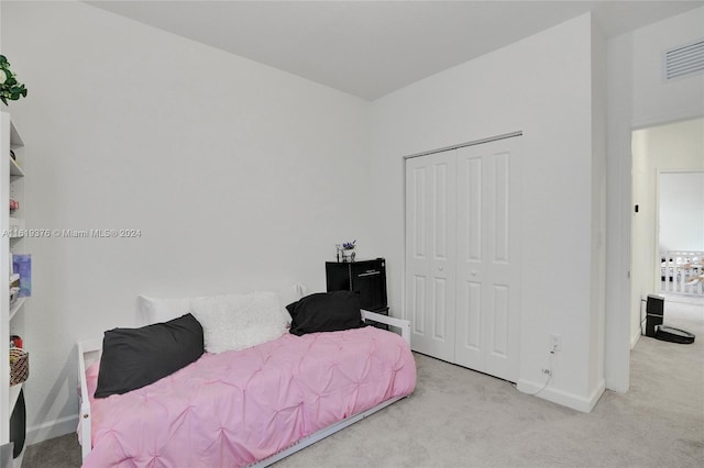 carpeted bedroom featuring a closet