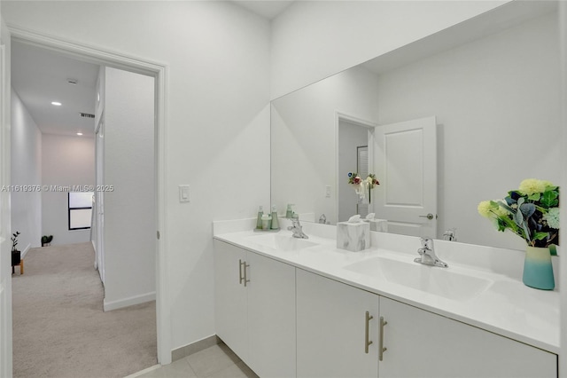 full bathroom featuring double vanity, a sink, visible vents, and baseboards