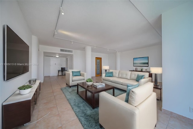 living room with light tile patterned floors and rail lighting