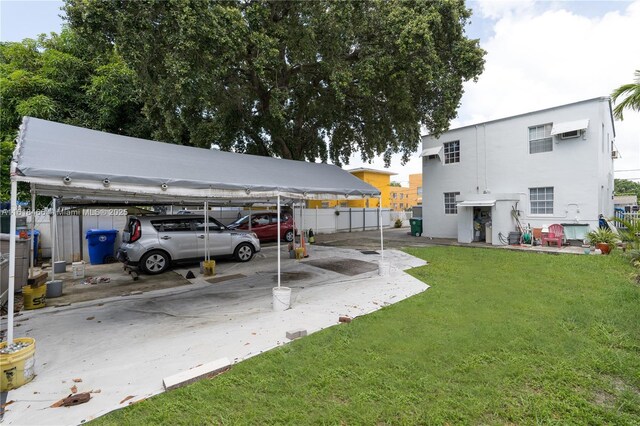 view of vehicle parking with a carport and a yard