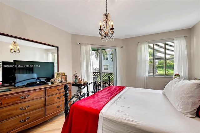 bedroom featuring a chandelier, light hardwood / wood-style flooring, and multiple windows