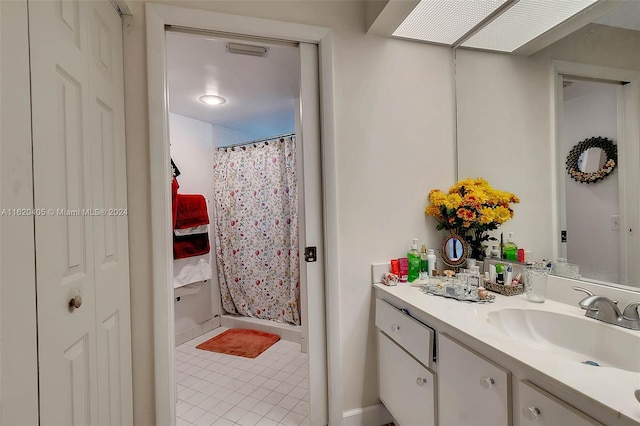 bathroom with tile patterned flooring, a shower with curtain, and vanity