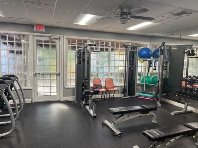 exercise room featuring a paneled ceiling and ceiling fan