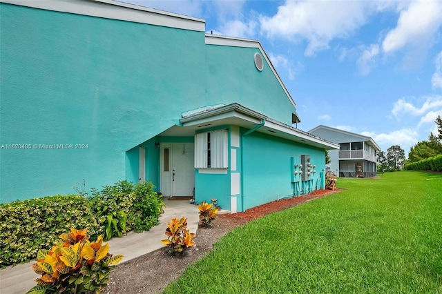 view of side of home with a yard