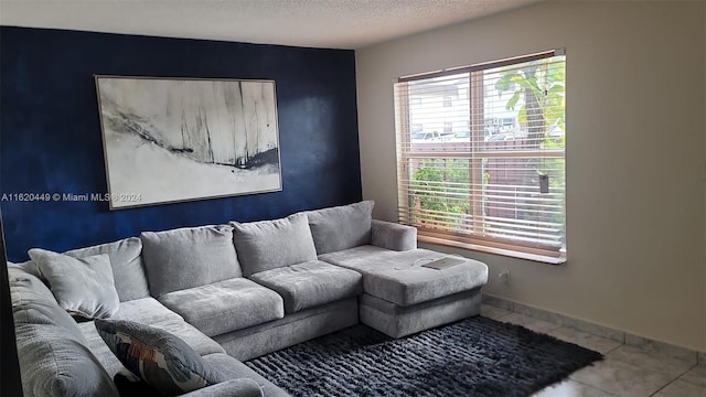 living room featuring a textured ceiling and tile patterned flooring