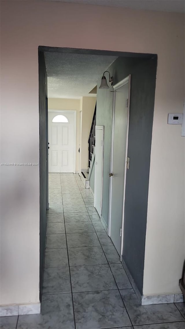 hallway featuring tile patterned flooring