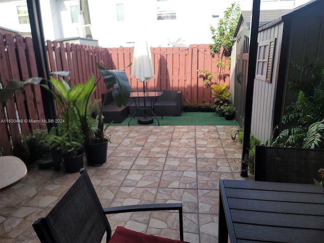 view of patio with a storage shed