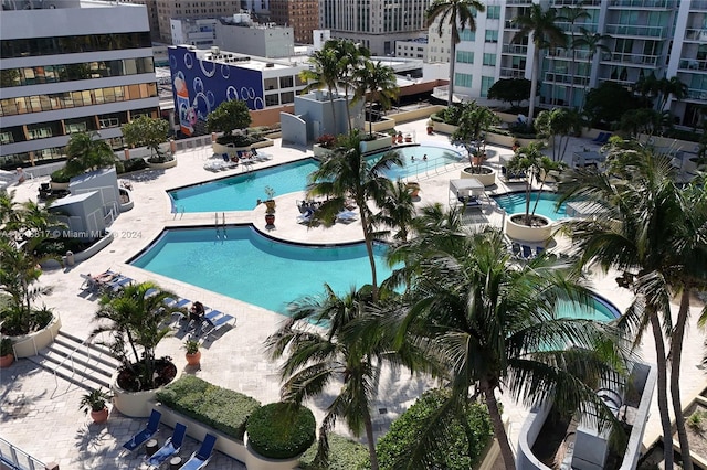 view of swimming pool with a patio area and a community hot tub