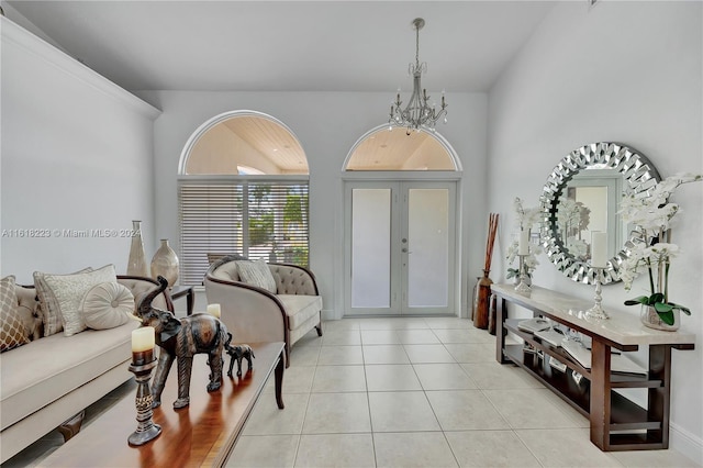 tiled entrance foyer featuring an inviting chandelier and french doors