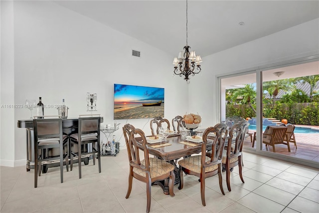 tiled dining space with lofted ceiling and a notable chandelier