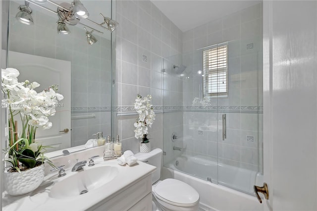 full bathroom featuring shower / bath combination with glass door, vanity, and toilet