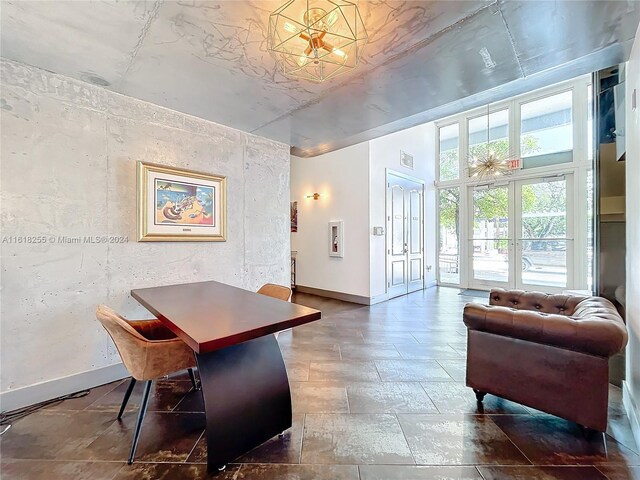 home office with a chandelier, french doors, and tile patterned floors