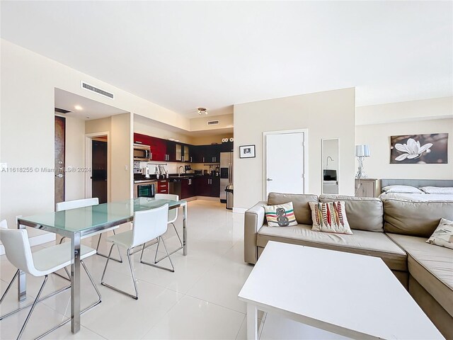 living room with sink and light tile patterned floors