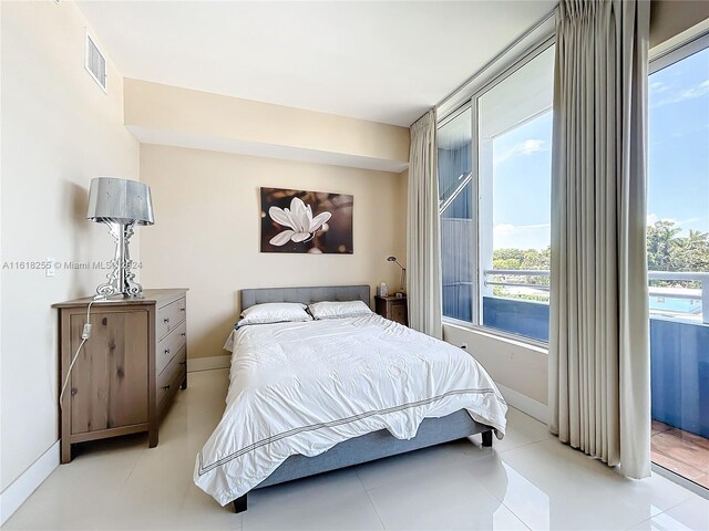 bedroom featuring light tile patterned flooring