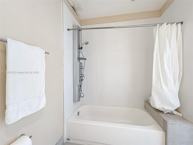 bathroom with shower / bath combination with curtain