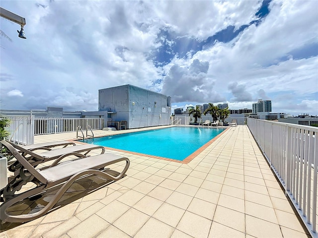 view of swimming pool with a patio