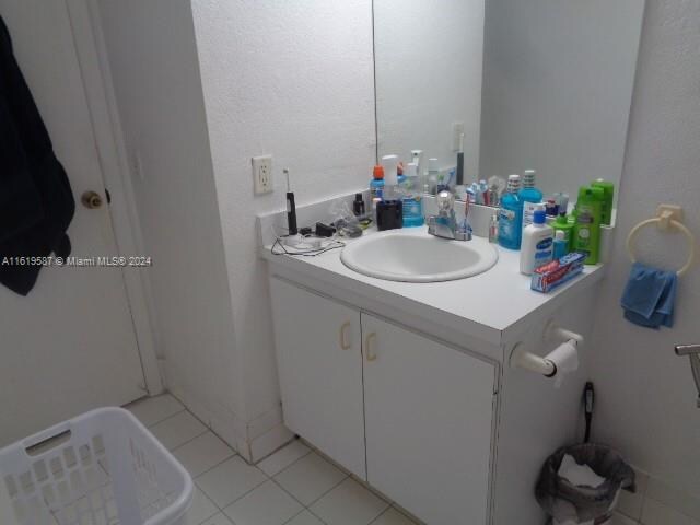 bathroom with tile patterned flooring and vanity