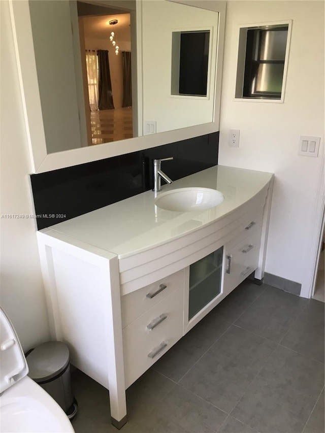 bathroom featuring tile patterned flooring, vanity, and toilet