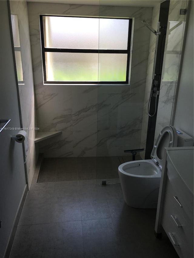 bathroom featuring toilet, a healthy amount of sunlight, and a tile shower