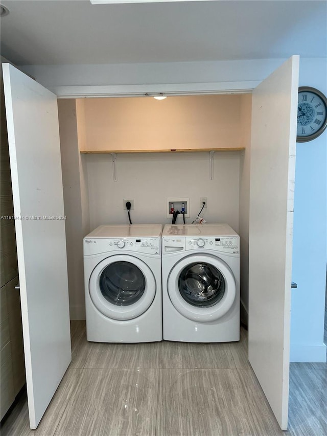 clothes washing area with washer and dryer and laundry area