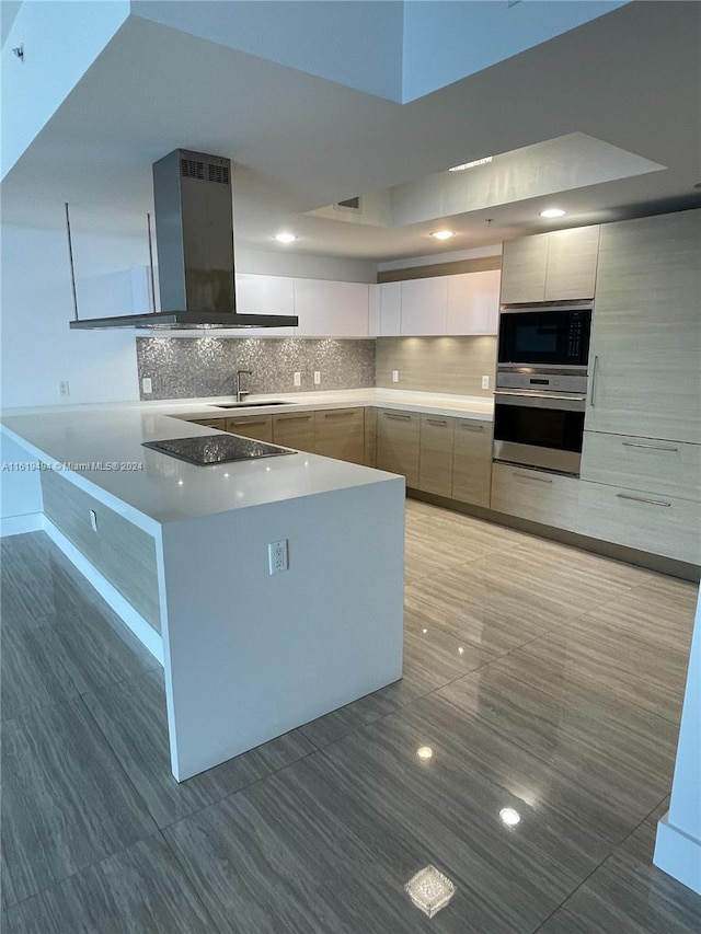 kitchen featuring island range hood, modern cabinets, black appliances, white cabinetry, and a sink