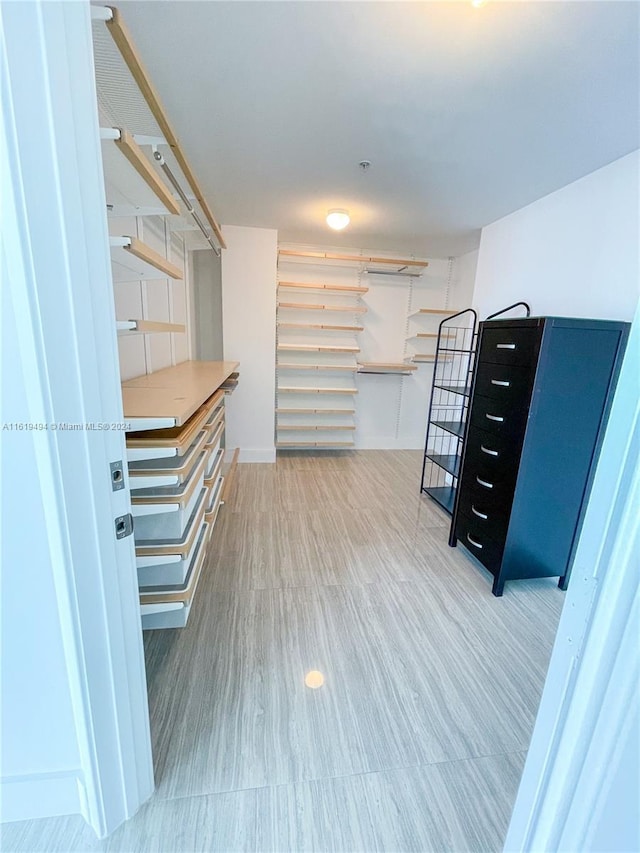 spacious closet featuring wood finished floors