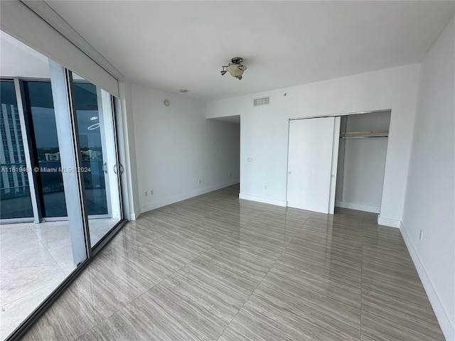 unfurnished bedroom featuring baseboards, visible vents, and french doors